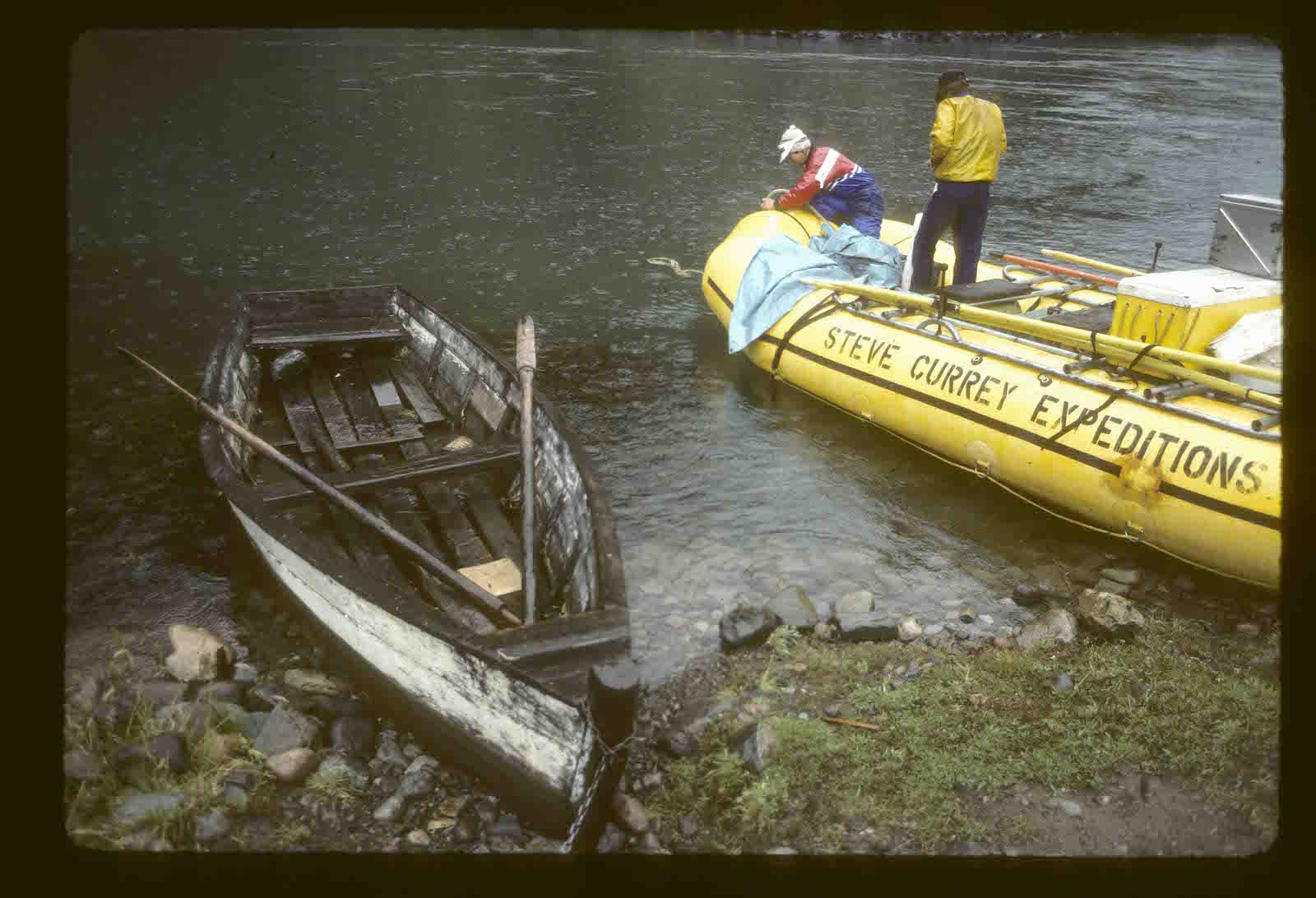 1985 first raft expedition on Futaleufú. Daniel Bolster topping off his 22' self bailing Maravia at put-in next to a local rowboat used to reach farms across the river without road access | Photo: Peter Fox